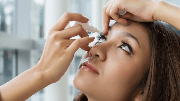 woman applying eye drops to relieve dry eyes